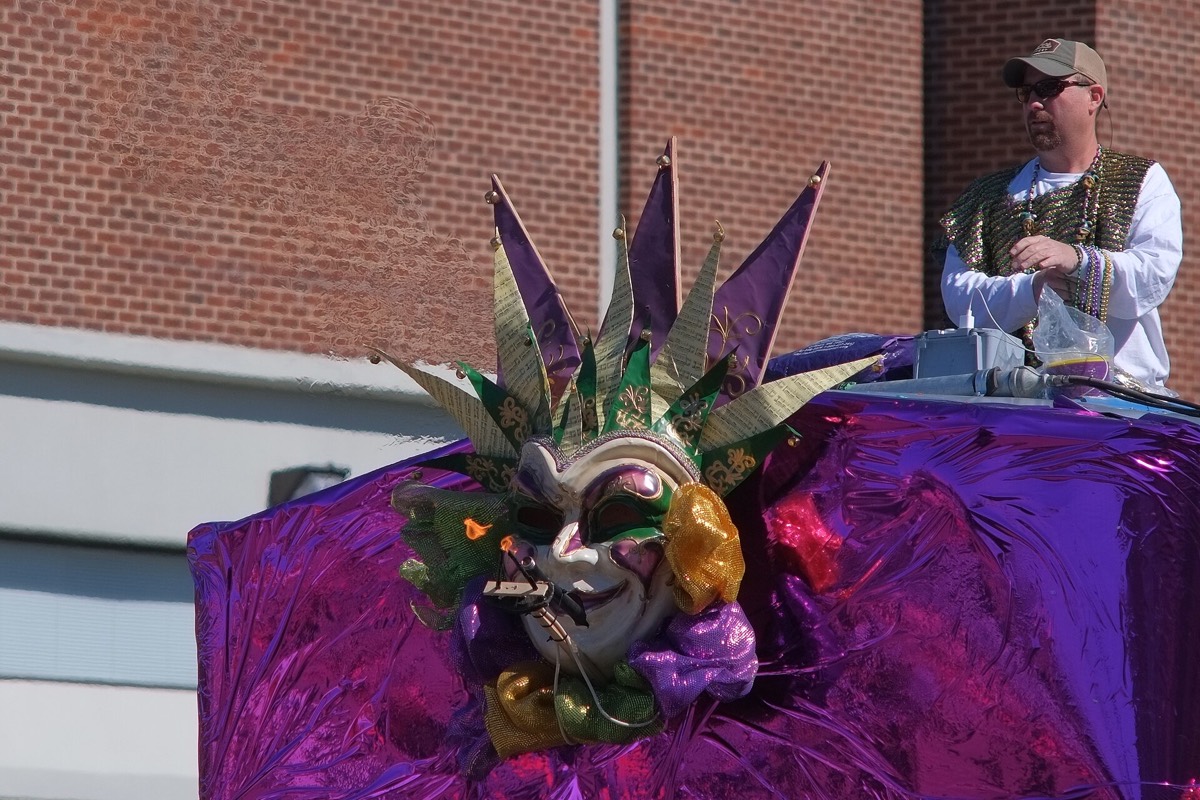 Mardi Gras float with a colorful carnival mask