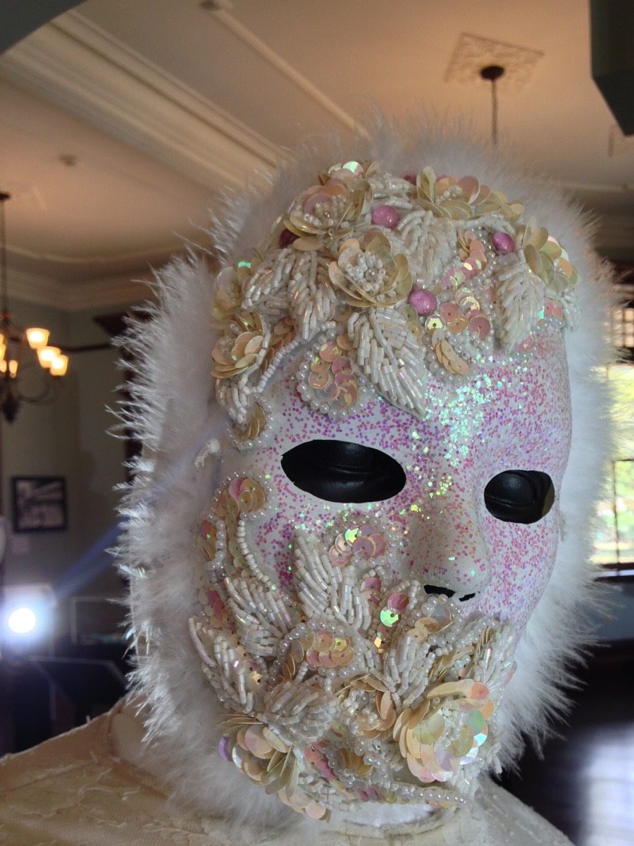 hand-finished carnival mask with feather trim